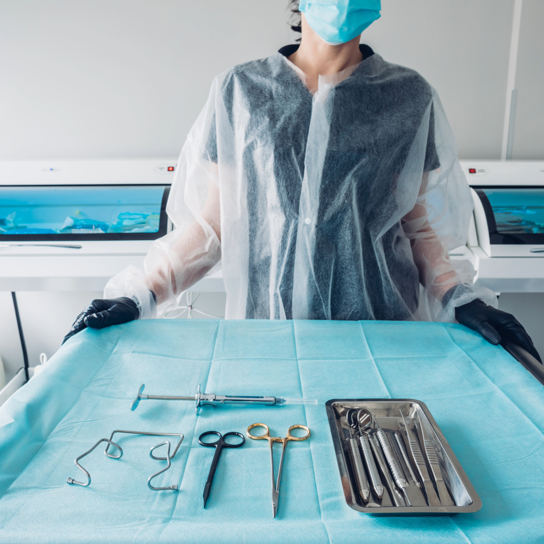 Dental assistant standing in front of a tray of oral surgery instruments